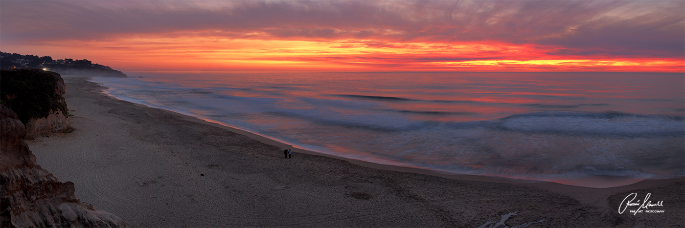 fiery sunset panorama of the California Coast near Half Moon Bay in October with people to scale