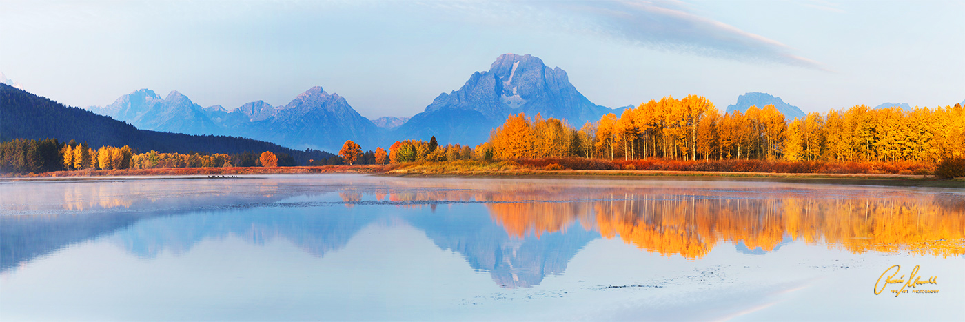 A horizontal 1:3 fine art panorama of Oxbow Bend at sunrise during the fall season ﻿in the Grand Tetons National Park, Wyoming